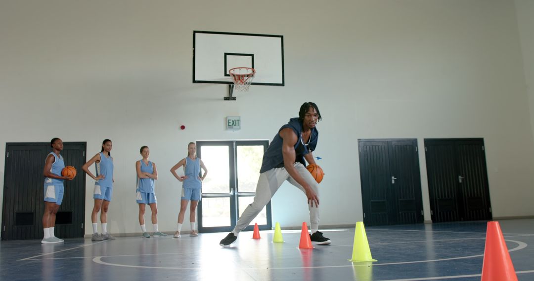 Group of Basketball Players Practicing Dribbling Skills Indoors