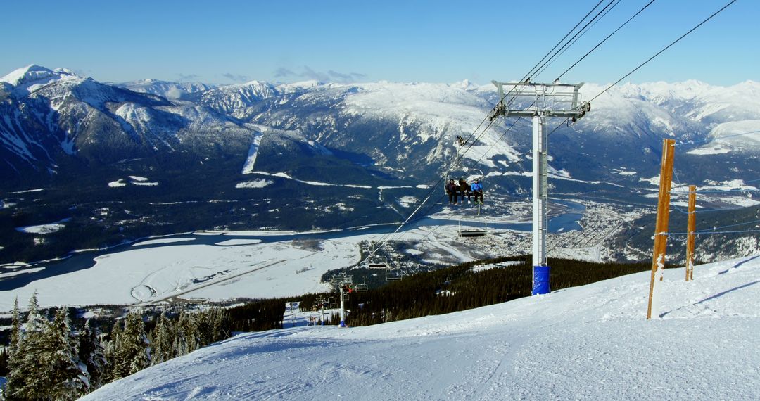 Skiers on Mountain Chairlift with Stunning Snowy Landscape - Free Images, Stock Photos and Pictures on Pikwizard.com