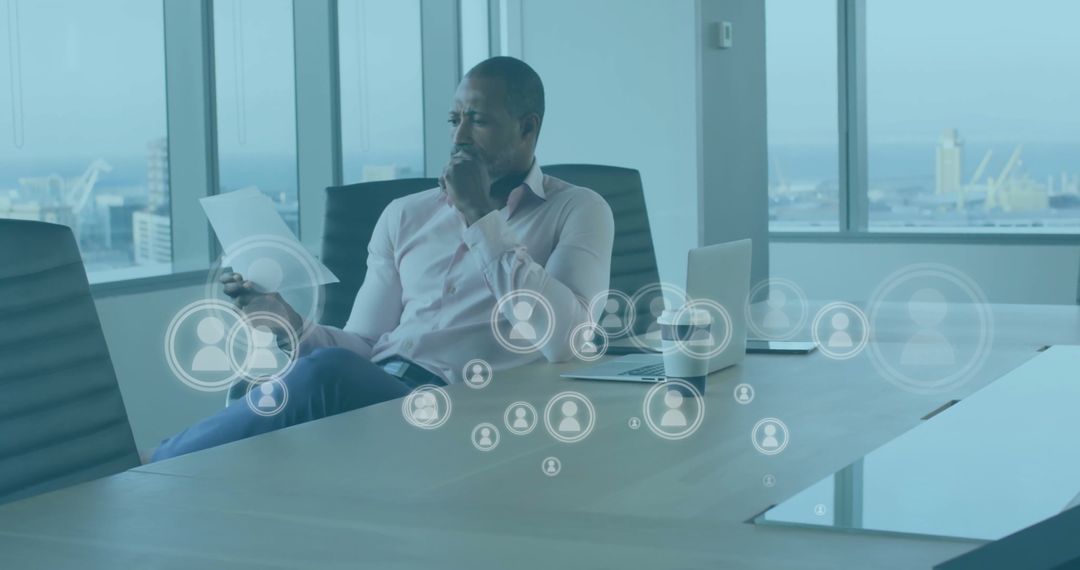 Businessman Analyzing Documents with Digital Media Interface