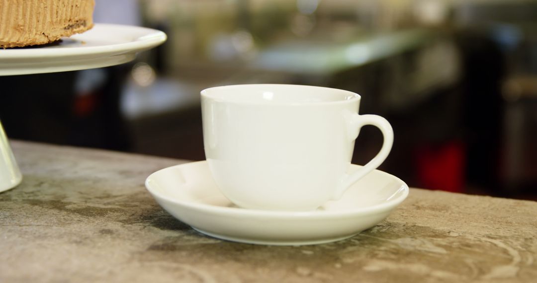 White Ceramic Tea Cup and Saucer on Rustic Countertop - Free Images, Stock Photos and Pictures on Pikwizard.com