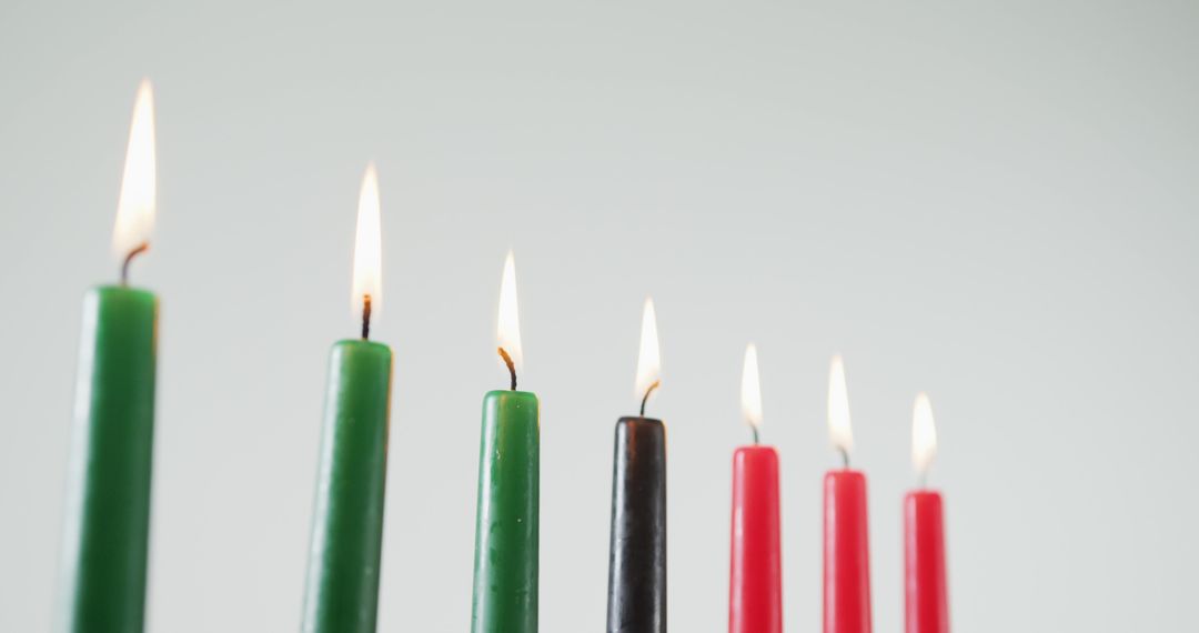 Kwanzaa Candles Displayed on Kinara Against White Background - Free Images, Stock Photos and Pictures on Pikwizard.com