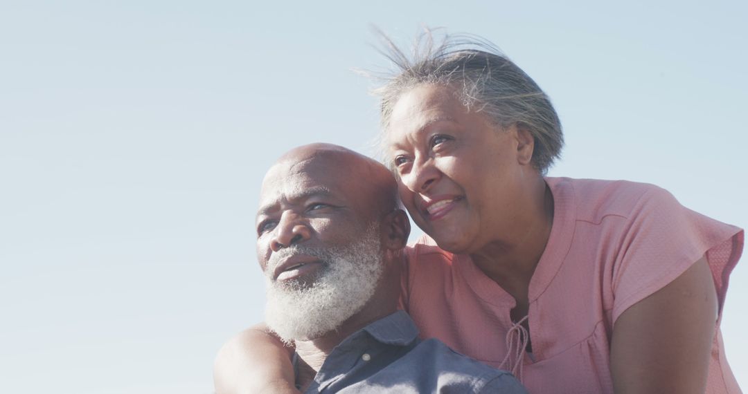 Senior Couple Embracing Outdoors under Blue Sky - Free Images, Stock Photos and Pictures on Pikwizard.com