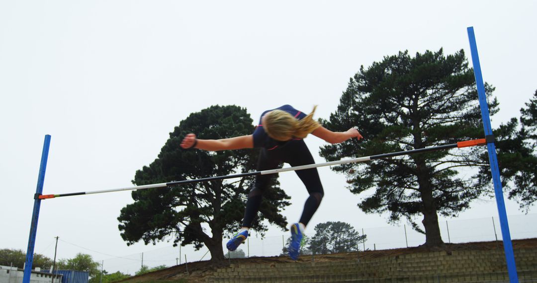 High Jumper Clearing Bar During Outdoor Track and Field Event - Free Images, Stock Photos and Pictures on Pikwizard.com