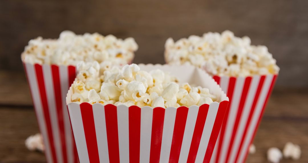 Close-Up of Popcorn Boxes on Wooden Table - Free Images, Stock Photos and Pictures on Pikwizard.com