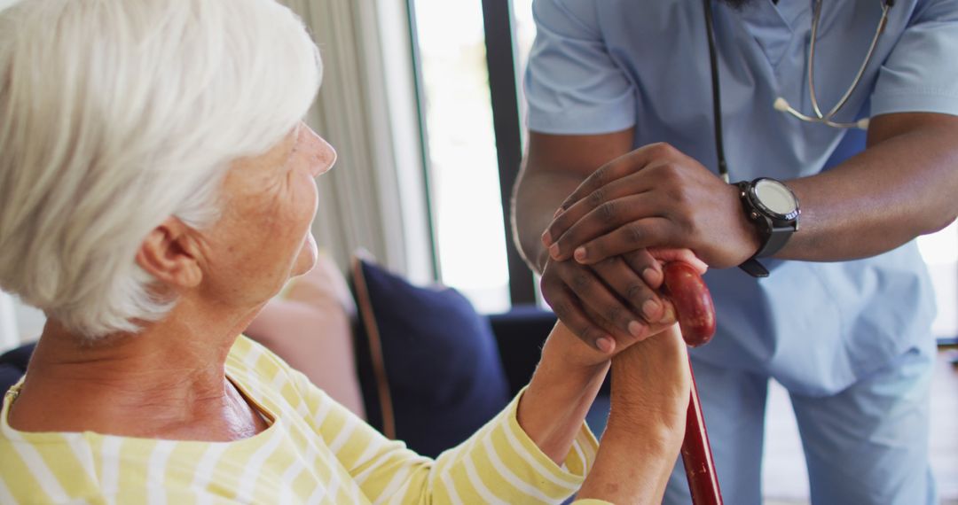 Doctor Assisting Elderly Woman with Walking Cane in Bright Room - Free Images, Stock Photos and Pictures on Pikwizard.com