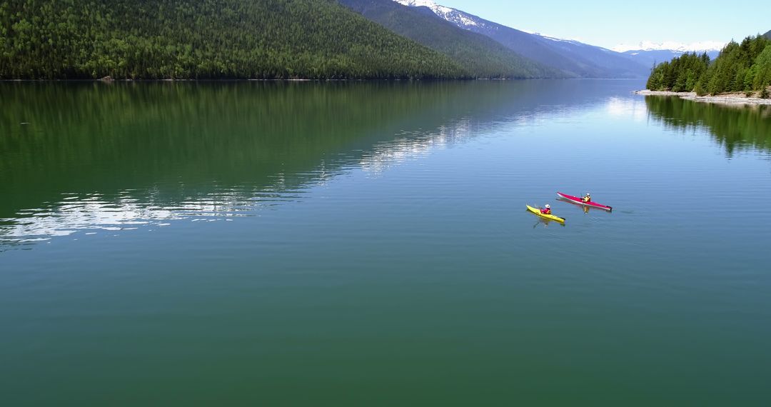 Serene Mountain Lake with Two Kayakers - Free Images, Stock Photos and Pictures on Pikwizard.com