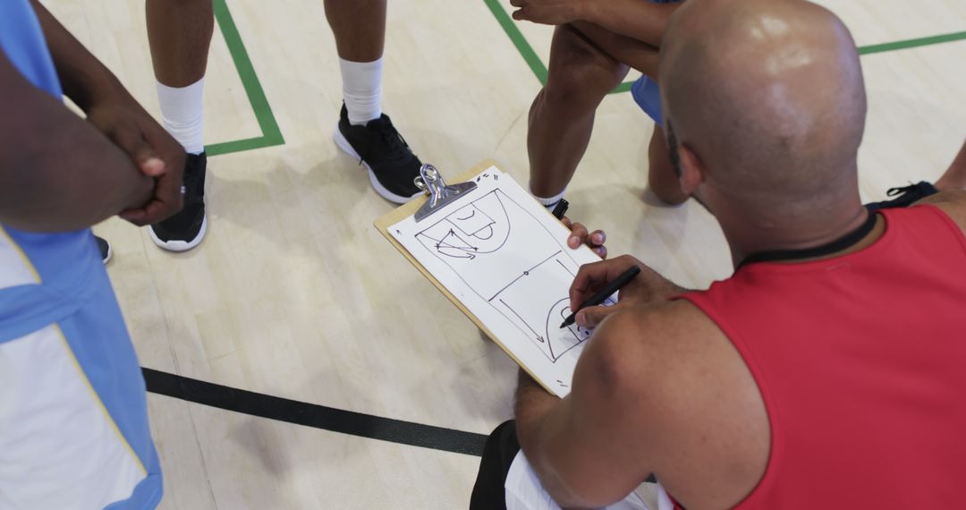 Basketball Coach Drawing Play on Clipboard with Team - Free Images, Stock Photos and Pictures on Pikwizard.com