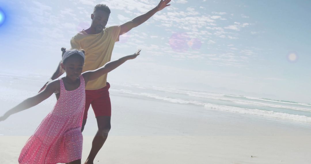 Father and Daughter Running with Joy on Sandy Beach