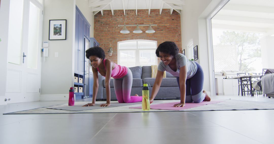 Young Women Practicing Yoga indoors in Modern Living room - Free Images, Stock Photos and Pictures on Pikwizard.com