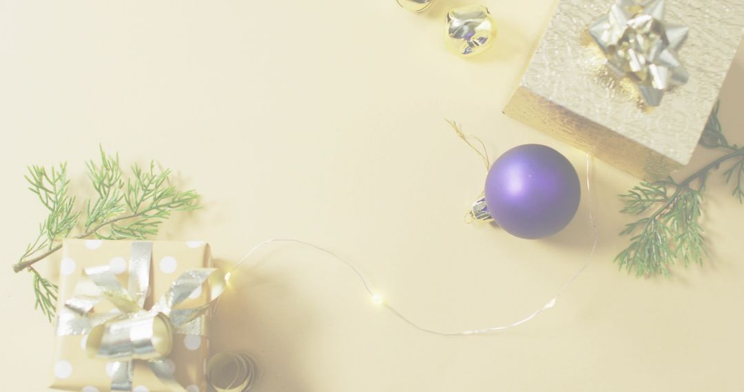 Minimal Holiday Flatlay Featuring Matte Purple Bauble, Wrapped Gifts and Warm Fairy Lights