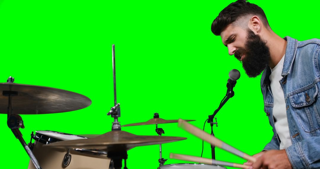 Bearded drummer rocking out with microphone on green screen backdrop - Free Images, Stock Photos and Pictures on Pikwizard.com