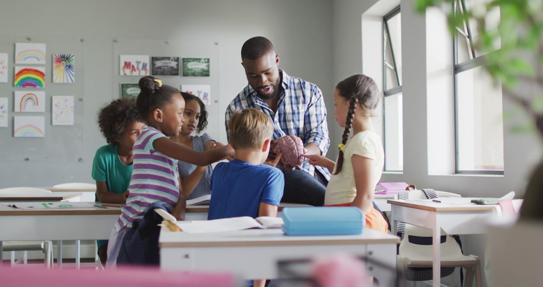 Image of happy african american male teacher and class of diverse pupils during biology lesson - Free Images, Stock Photos and Pictures on Pikwizard.com