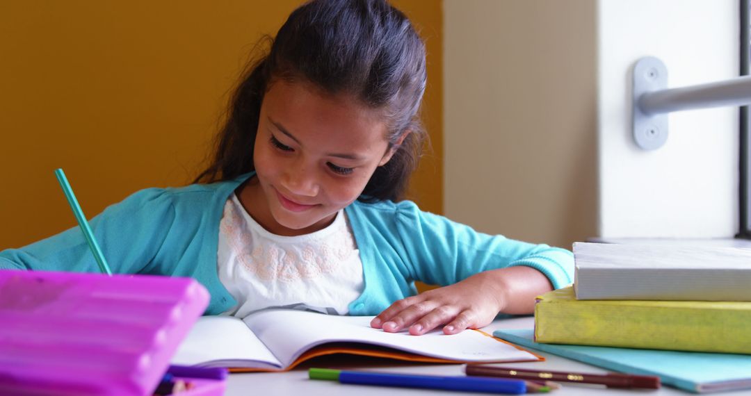 Young Girl Studying at School Desk with Books and Pencils