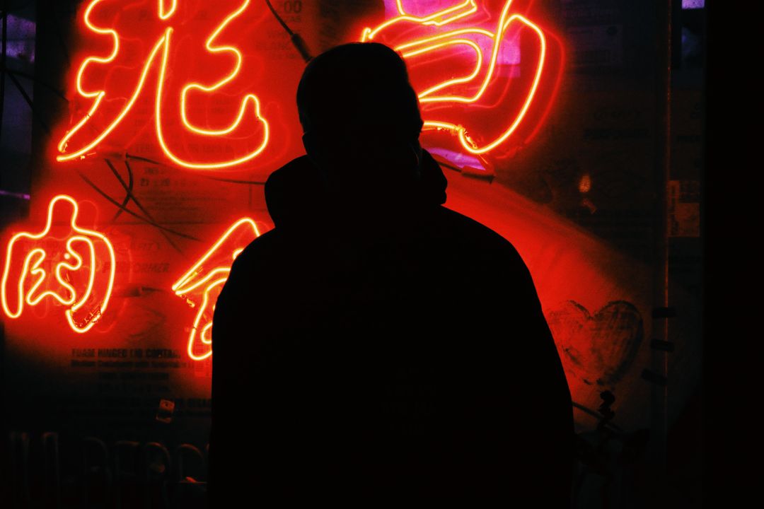 Silhouette of Person in Front of Neon Signs at Night - Free Images, Stock Photos and Pictures on Pikwizard.com