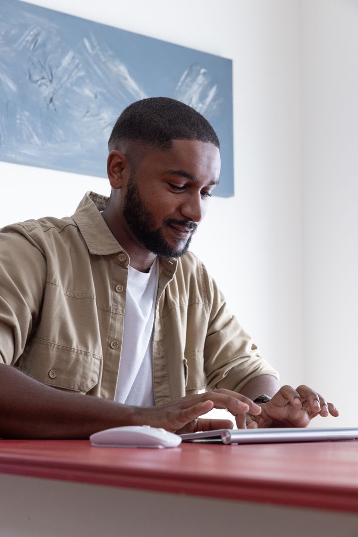 Young Professional Using Tablet at Modern Minimalist Workspace