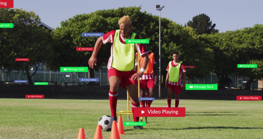 Male Soccer Player Dribbling Through Training Cones on Field