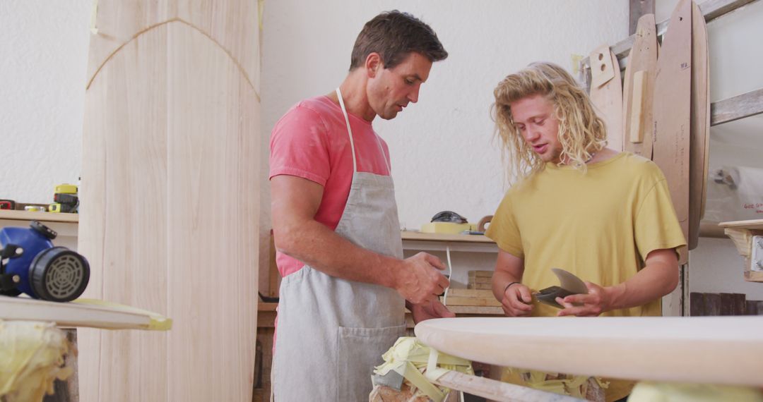 Craftsmen Shaping Surfboards in Workshop - Free Images, Stock Photos and Pictures on Pikwizard.com