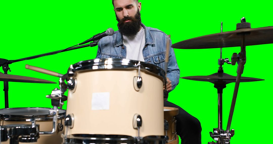 Bearded Drummer Performing in Denim Jacket on Green Screen Background - Free Images, Stock Photos and Pictures on Pikwizard.com