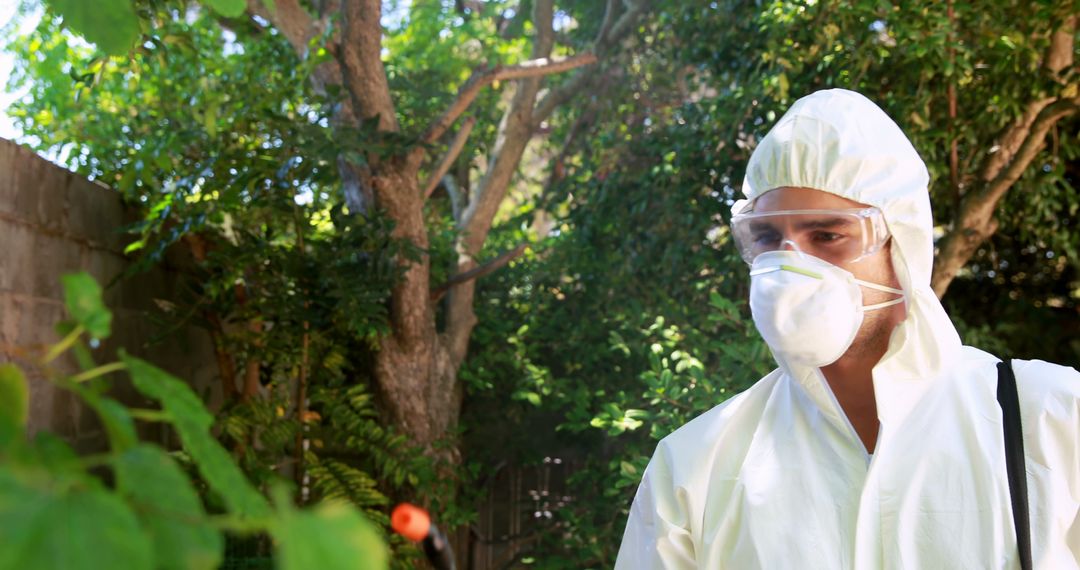 Pest Control Worker in Protective Gear Spraying Outdoors - Free Images, Stock Photos and Pictures on Pikwizard.com