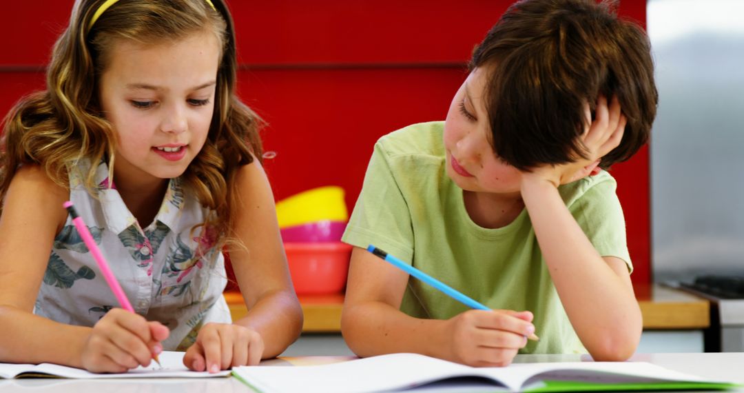 Two Children Collaborating on Homework in Classroom - Free Images, Stock Photos and Pictures on Pikwizard.com