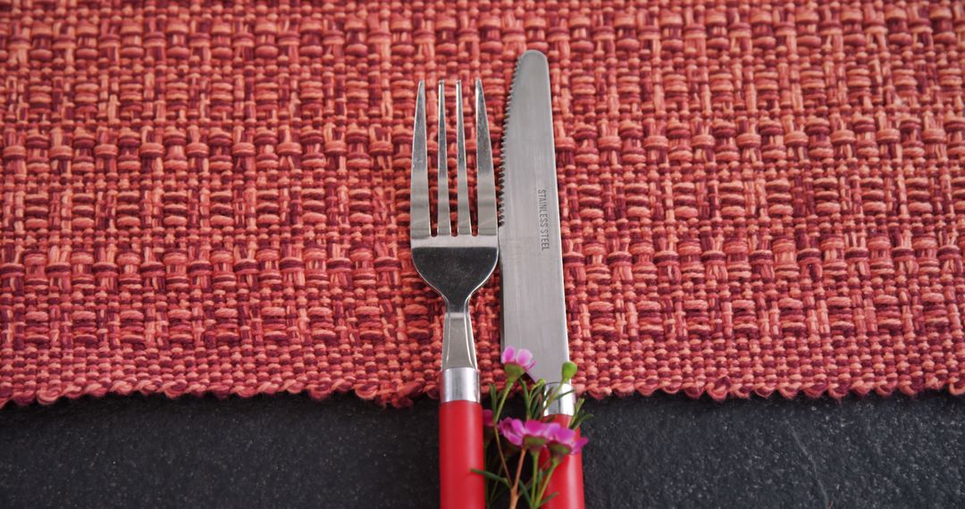 Closeup Of Fork And Knife On Decorative Red Placemat - Free Images, Stock Photos and Pictures on Pikwizard.com