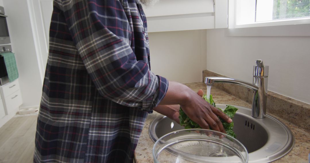 Senior Man Washing Fresh Vegetables in Home Kitchen - Free Images, Stock Photos and Pictures on Pikwizard.com