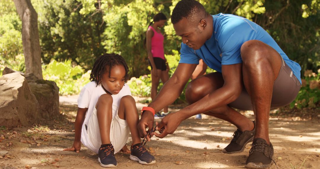 Father Helping Son Tie Shoelaces During Outdoor Activity - Free Images, Stock Photos and Pictures on Pikwizard.com