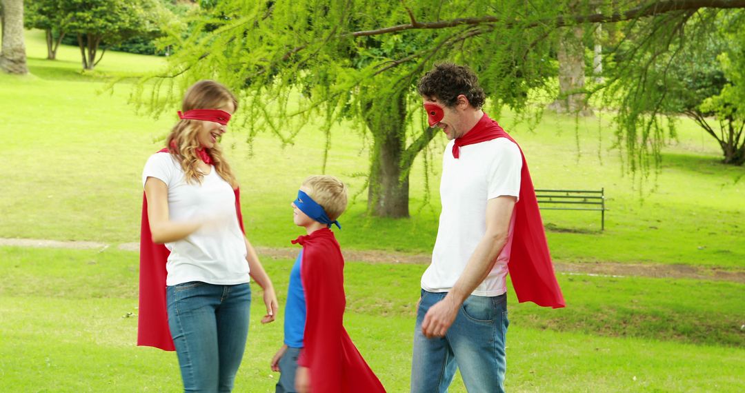 Family Enjoying Outdoor Playtime Dressed as Superheroes - Free Images, Stock Photos and Pictures on Pikwizard.com