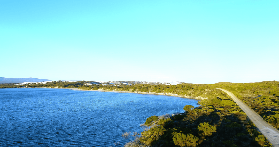Transparent Scenic Coastal Landscape Under Clear Blue Sky