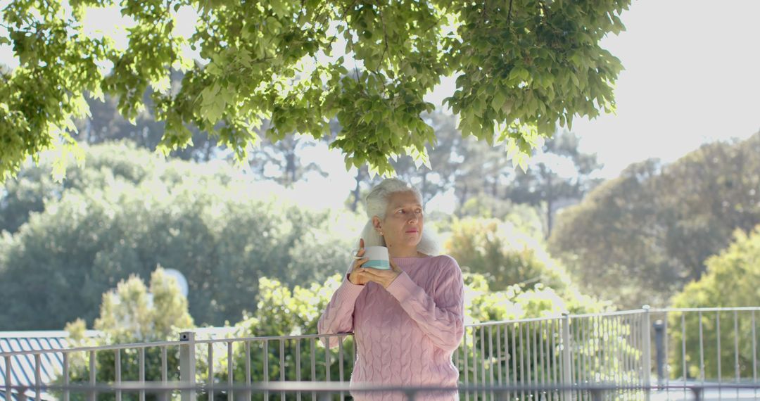 Senior Woman Relaxing in Park, Standing Under Tree - Free Images, Stock Photos and Pictures on Pikwizard.com