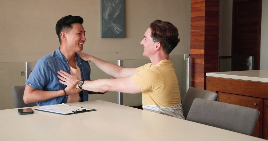 Smiling Friends Sharing Encouragement at Home Table