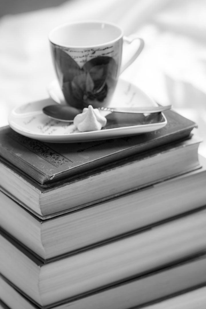 Cup and Saucer with Spoon on Stack of Books in Black and White - Free Images, Stock Photos and Pictures on Pikwizard.com