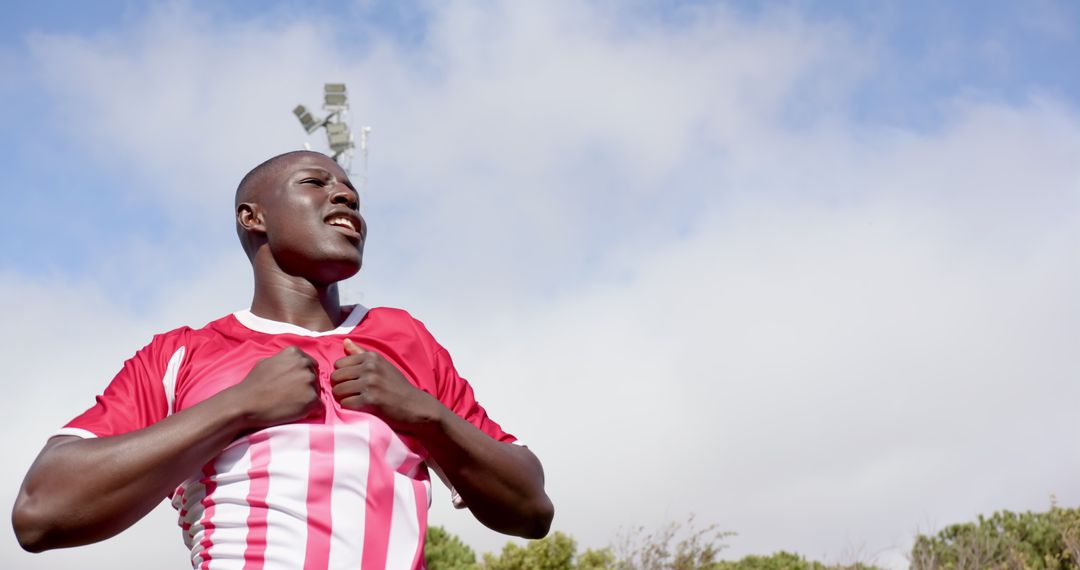 Determined Soccer Player Pulling Jersey on Field