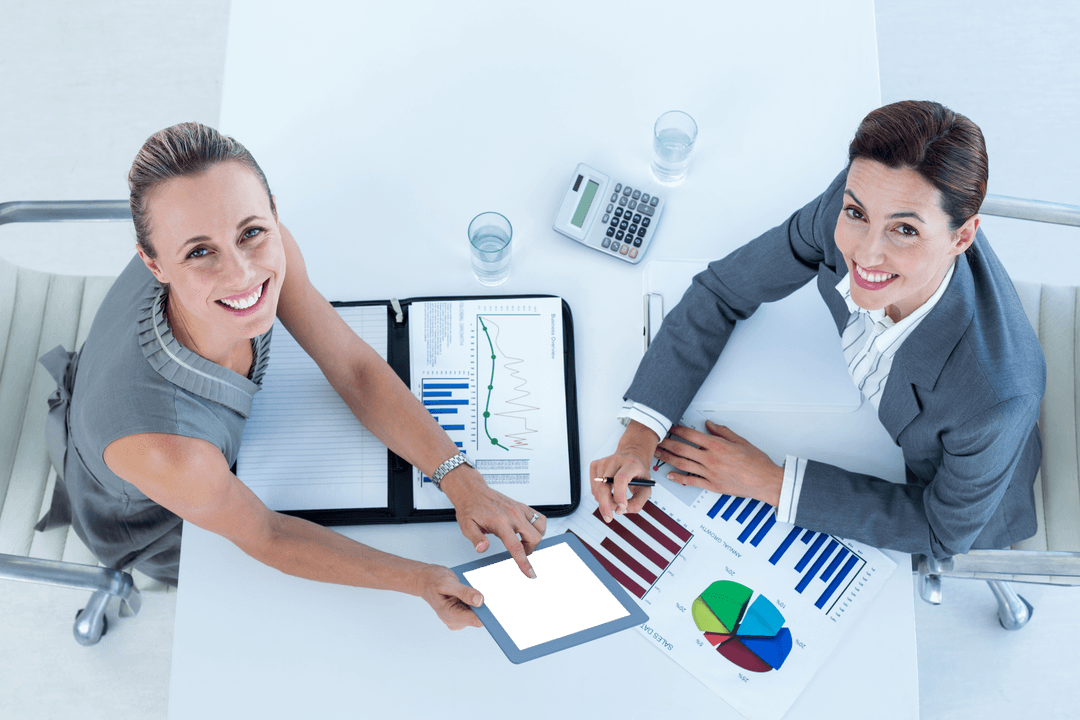 Transparent Collaboration: Businesswomen Analyzing Data Together in Modern Office