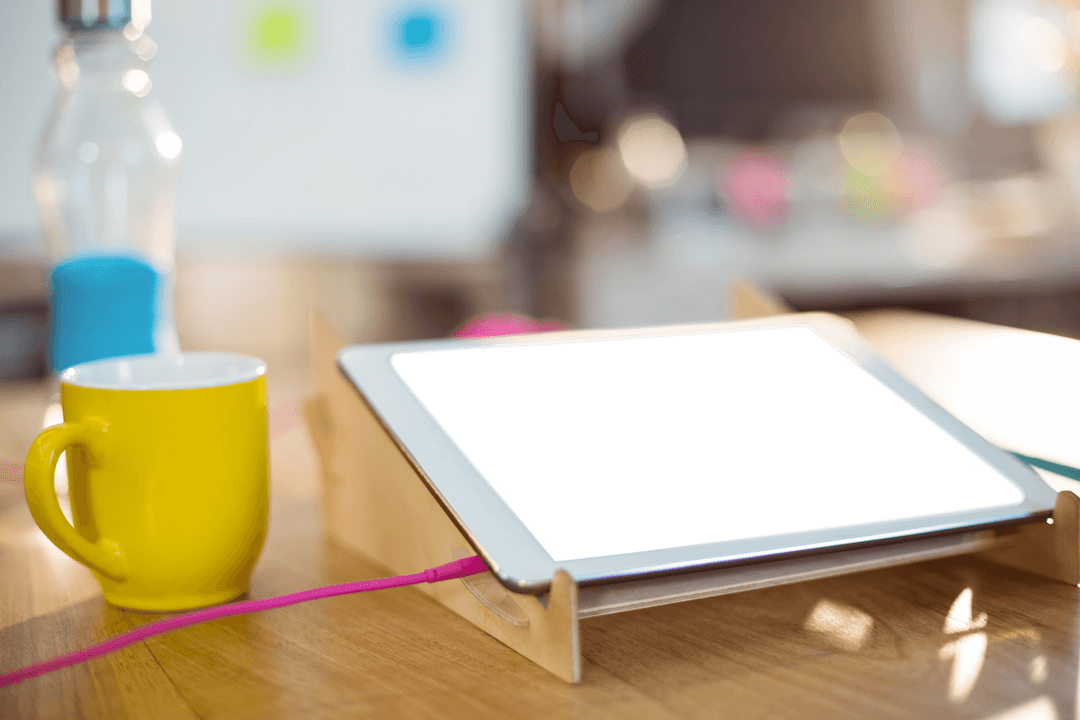 Digital Tablet with Coffee Cup on Transparent Office Desk