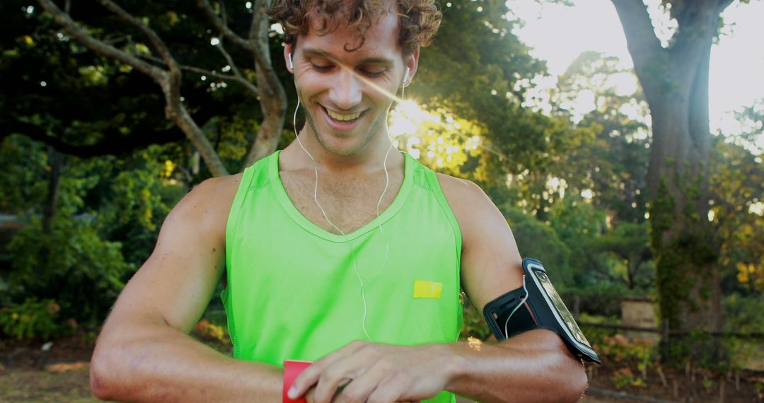 Young Man Running in Park Checking Smartwatch Fitness Progress - Free Images, Stock Photos and Pictures on Pikwizard.com