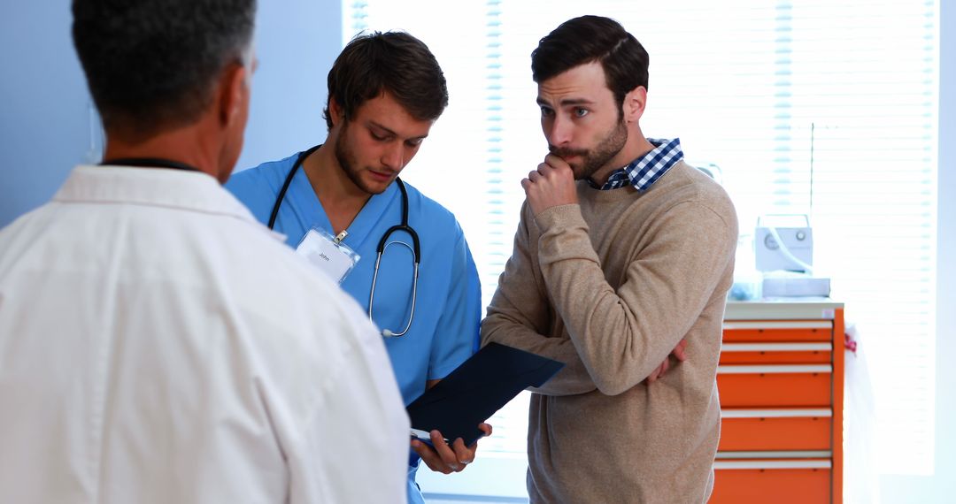 Two Doctors and Concerned Patient Discussing Test Results - Free Images, Stock Photos and Pictures on Pikwizard.com