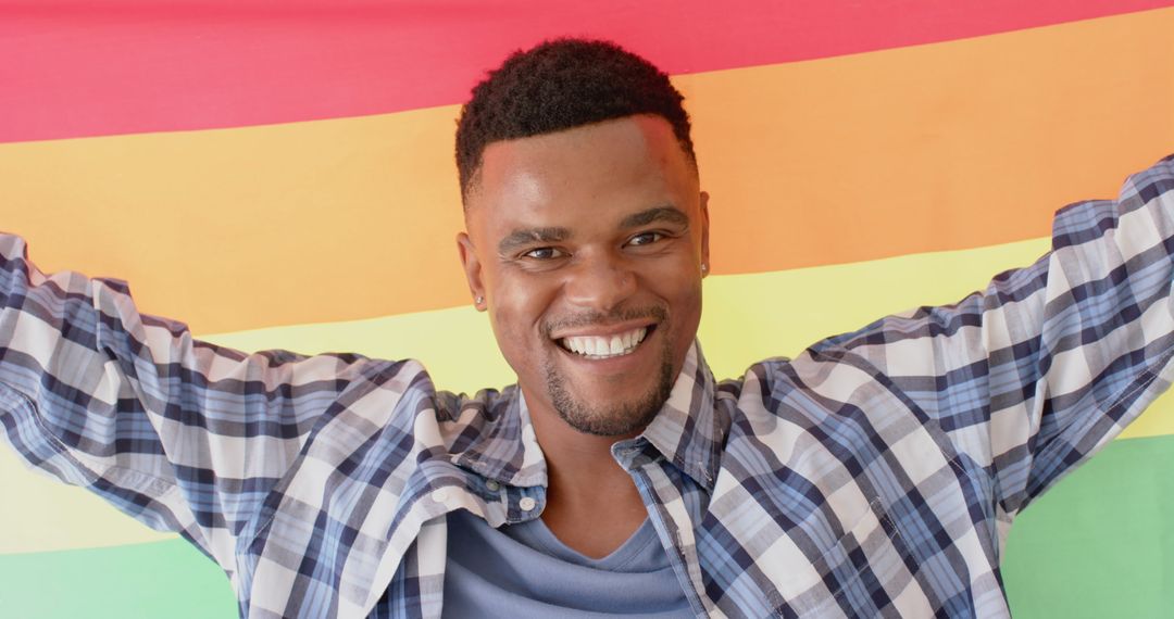Celebrating Love and Diversity as Joyful Man Holds Rainbow Flag