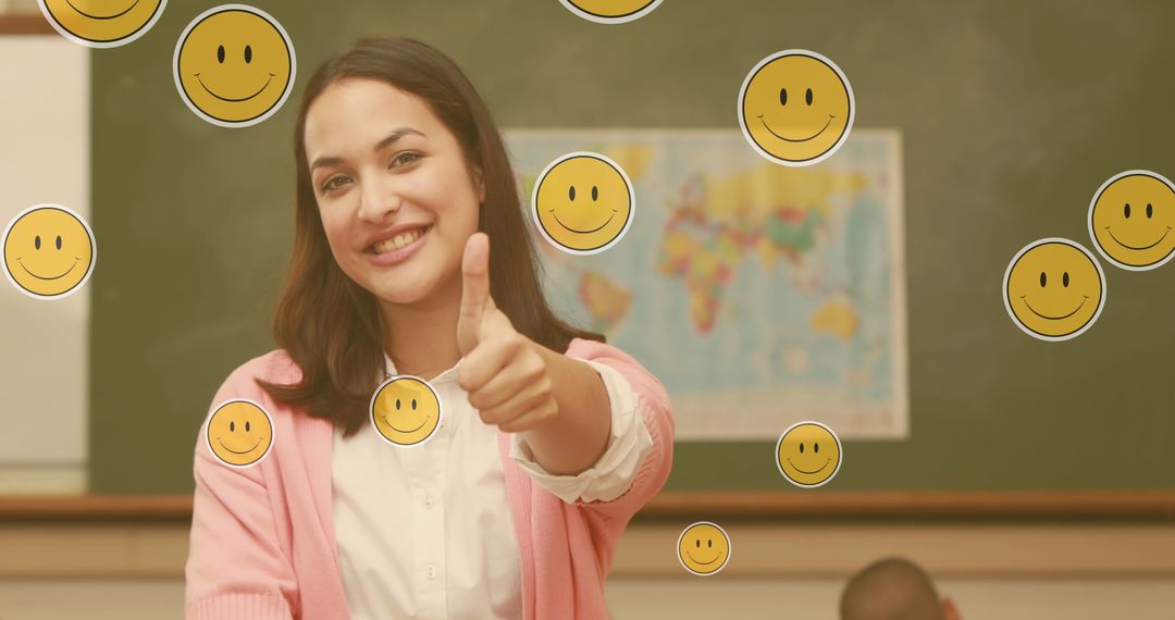 Happy teacher giving thumbs up with floating emojis in classroom