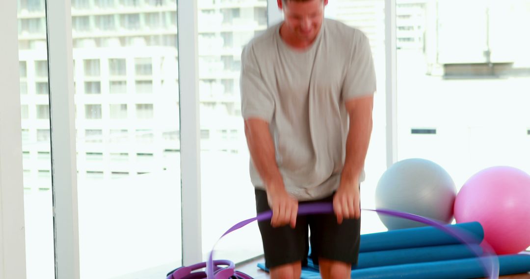 Man Exercising with Resistance Bands in Modern Fitness Studio - Free Images, Stock Photos and Pictures on Pikwizard.com