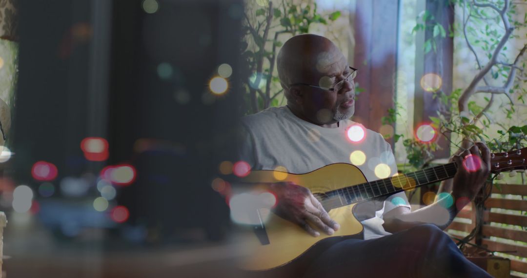Senior African Man Enjoying Guitar with Vibrant Bokeh Overlay