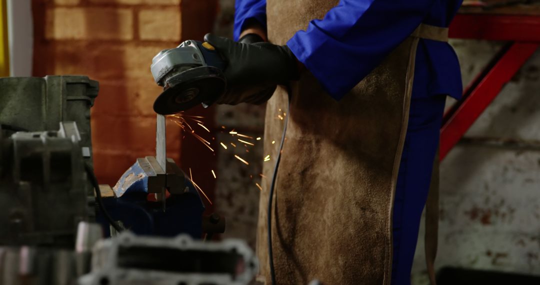 Factory Worker Using Angle Grinder On Metal Bar Generating Sparks - Free Images, Stock Photos and Pictures on Pikwizard.com