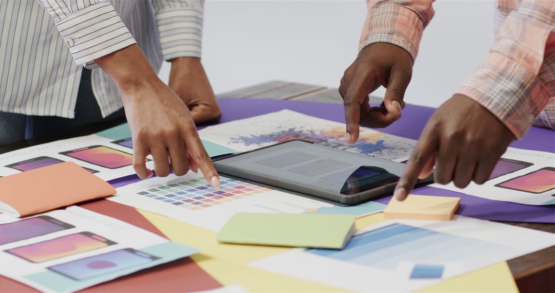 Designers Collaborating Over Smartphone Interface Plans