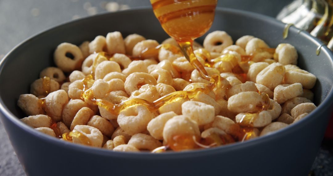 Honey Drizzling on Breakfast Cereal in a Bowl - Free Images, Stock Photos and Pictures on Pikwizard.com