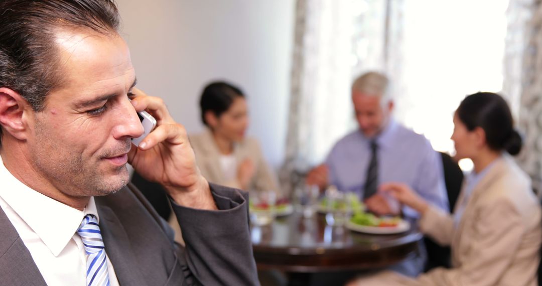 Businessman Talking on Phone at Business Meeting During Lunch - Free Images, Stock Photos and Pictures on Pikwizard.com