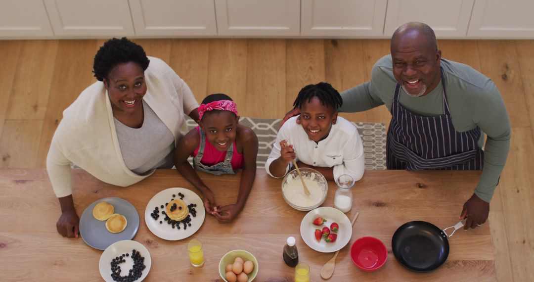 Happy Family Preparing Breakfast Smiling in Kitchen - Free Images, Stock Photos and Pictures on Pikwizard.com