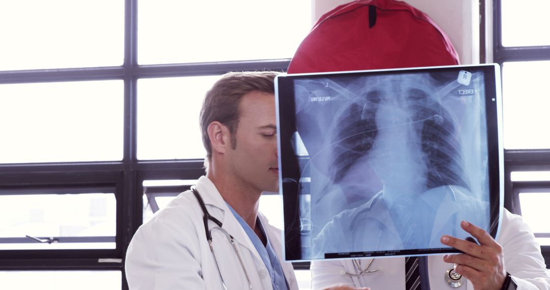 Doctors Examining Chest X-Ray in Medical Facility - Free Images, Stock Photos and Pictures on Pikwizard.com