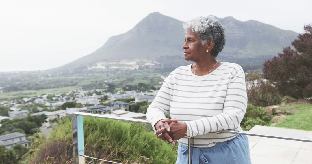 Senior Woman Relaxing on Balcony with Scenic Mountain View - Free Images, Stock Photos and Pictures on Pikwizard.com