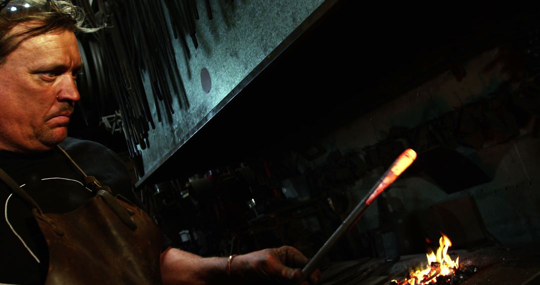 Experienced Blacksmith Forging Metal in Workshop - Free Images, Stock Photos and Pictures on Pikwizard.com