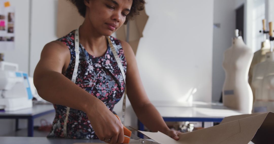 Fashion Designer Cutting Patterns in Studio Workspace